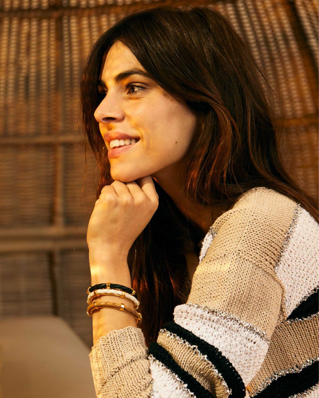 Our Lisbon bracelets in camel, black and chalk woven lambskin are seen worn in accumulation by our model.