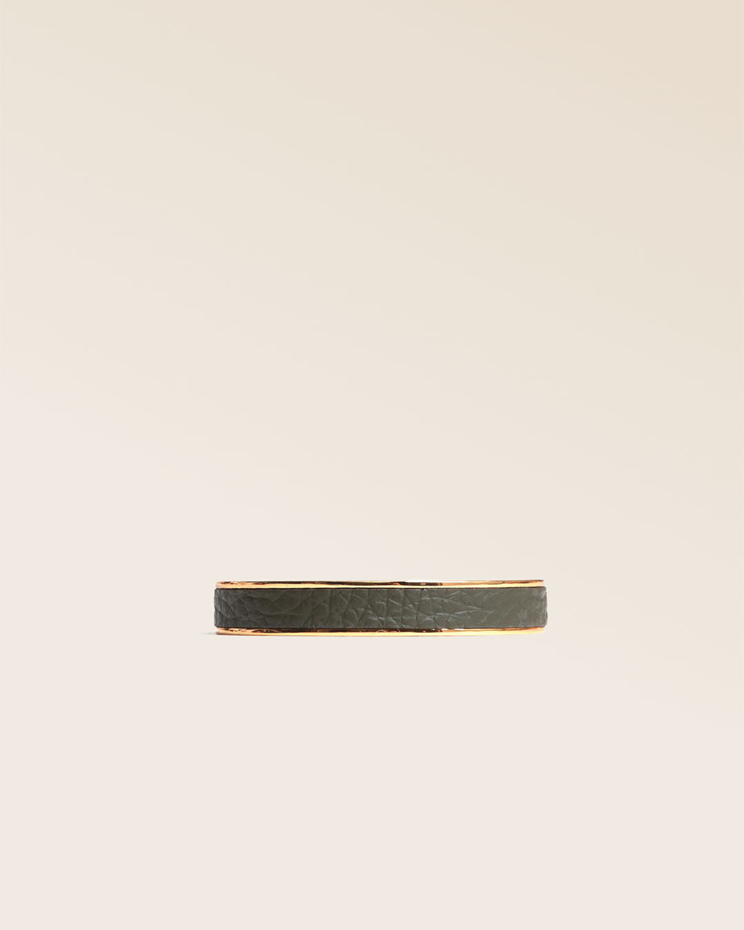 Our golden Pacôme bracelet in khaki vicuña-style leather, seen from the front in the studio.