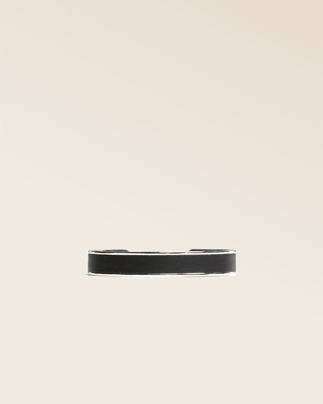 Our Pacôme Renouard bracelet in nickel-plated metal and smooth black leather, seen from the front in the studio.