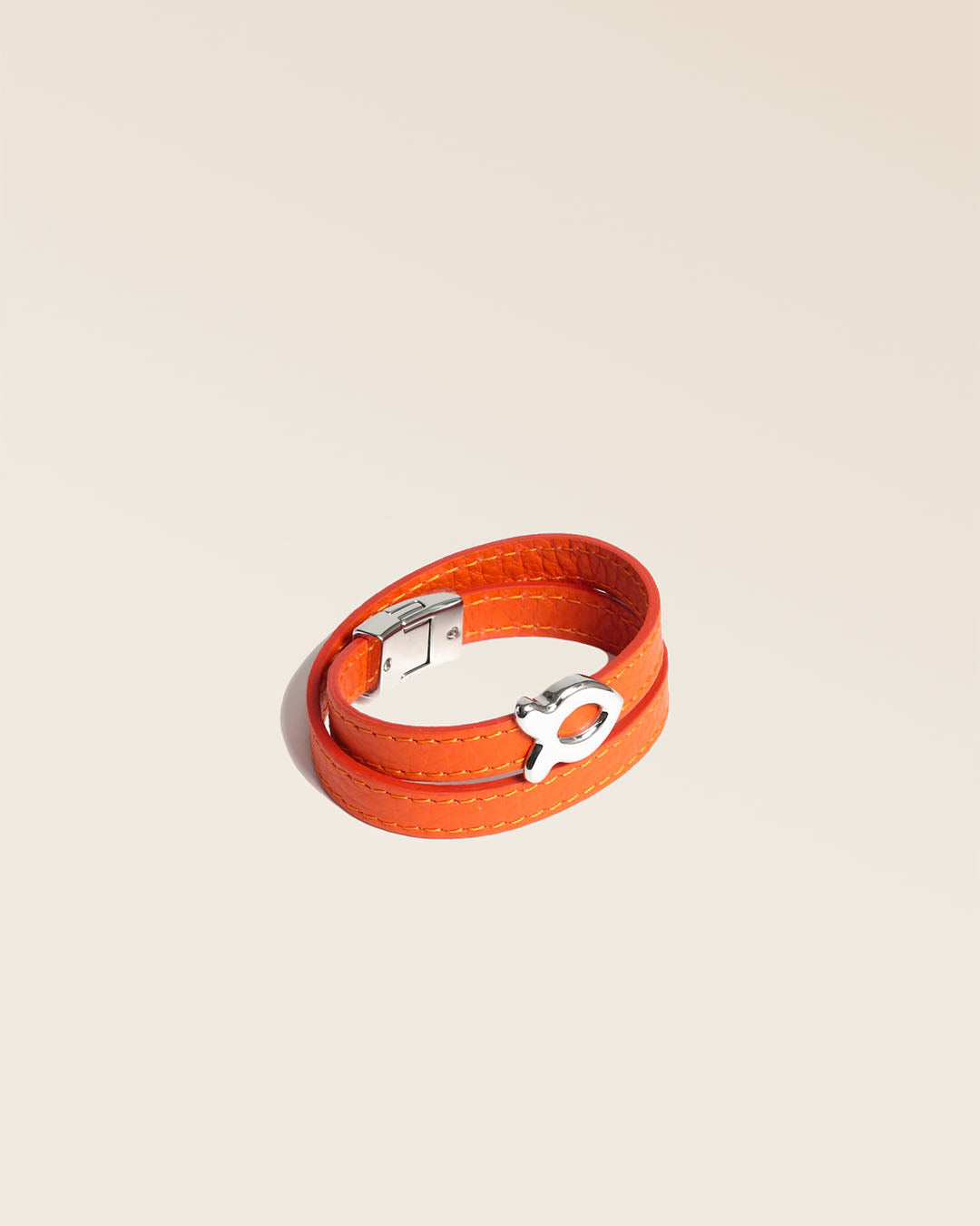 Our nickel-plated Sardine bracelet in orange vicuña leather as seen from the quarter in the studio.
