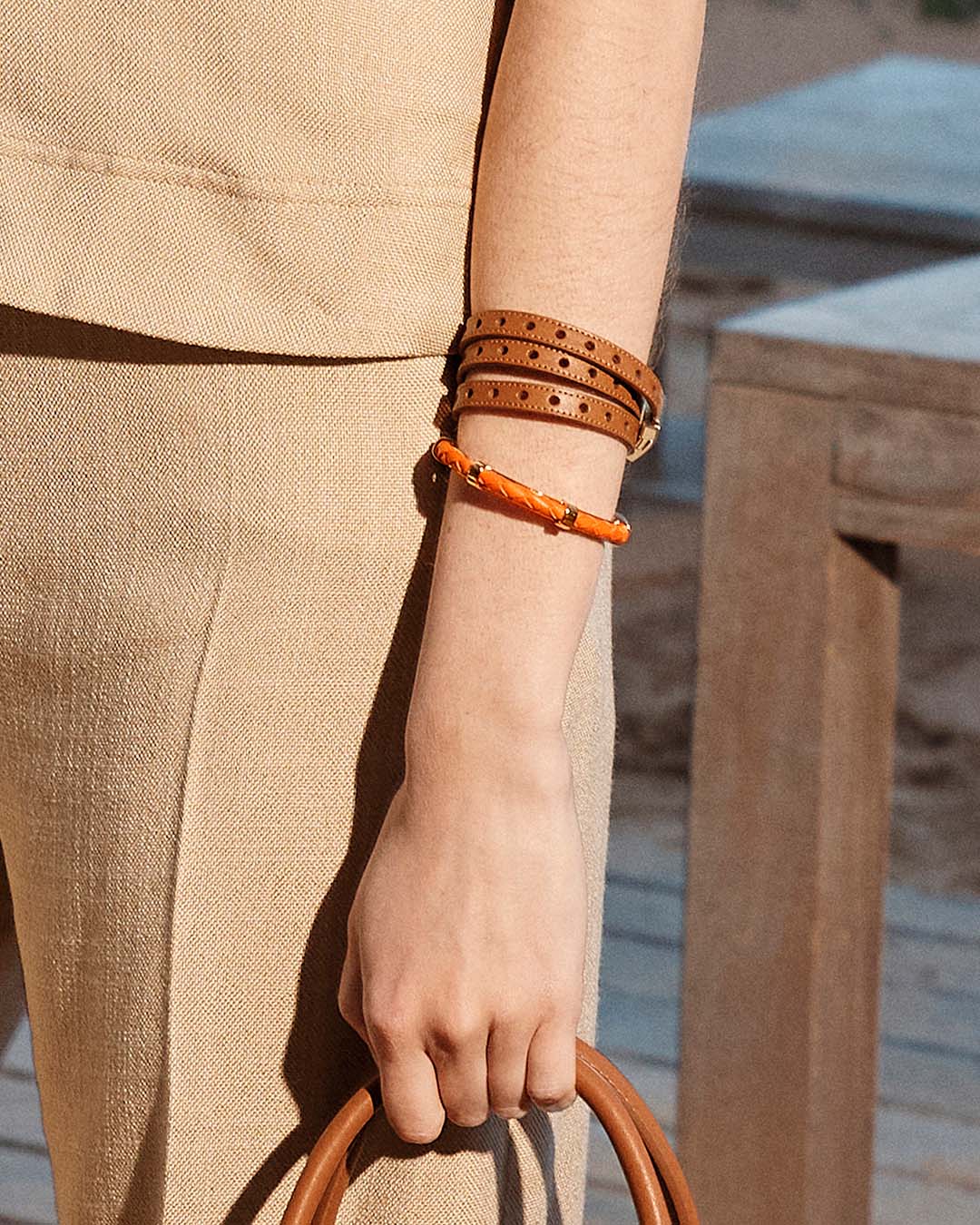 Our Totem bracelet in camel perforated lambskin seen from the front worn by our model.