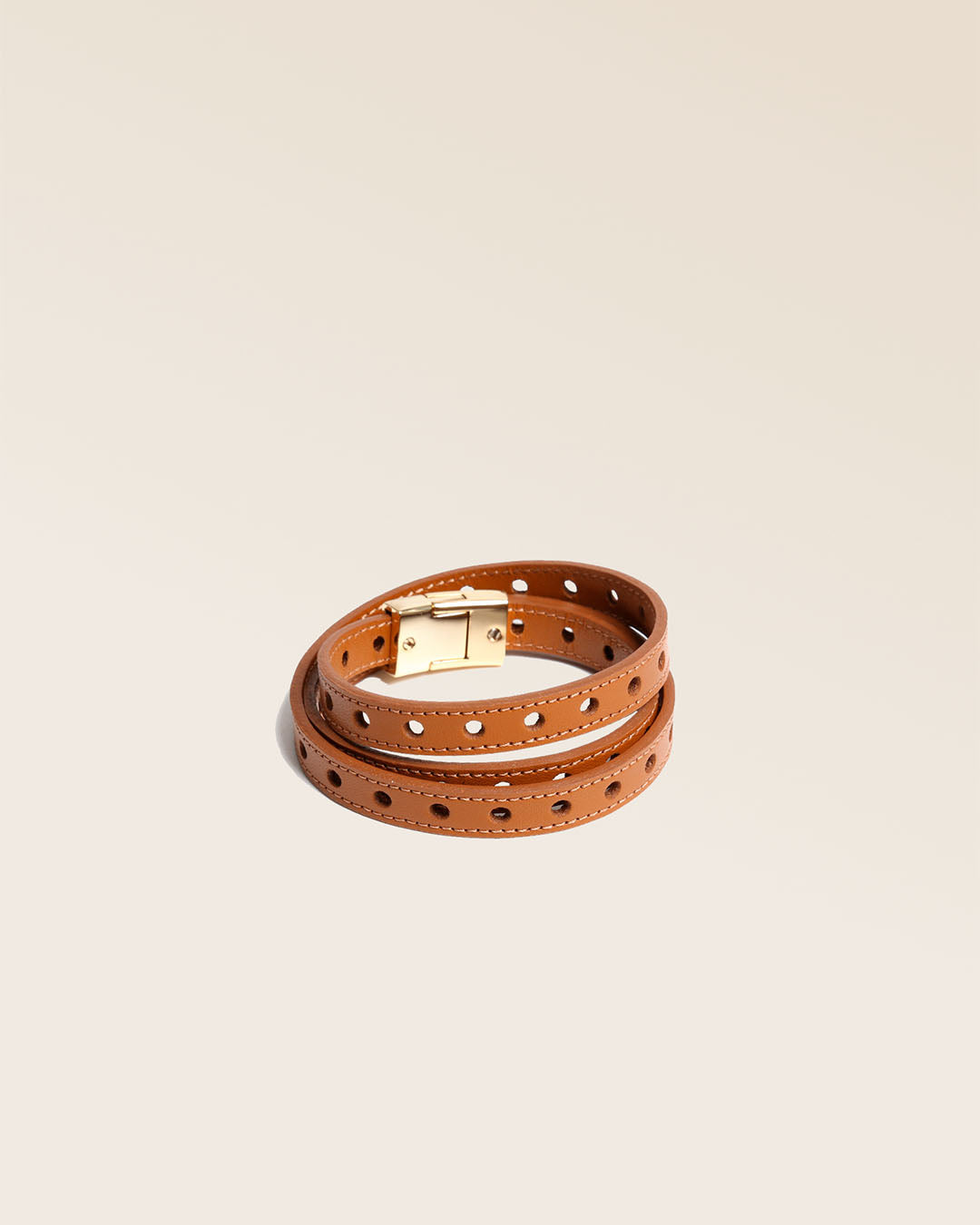 Our Totem bracelet in camel perforated lambskin seen from the quarter in the studio.