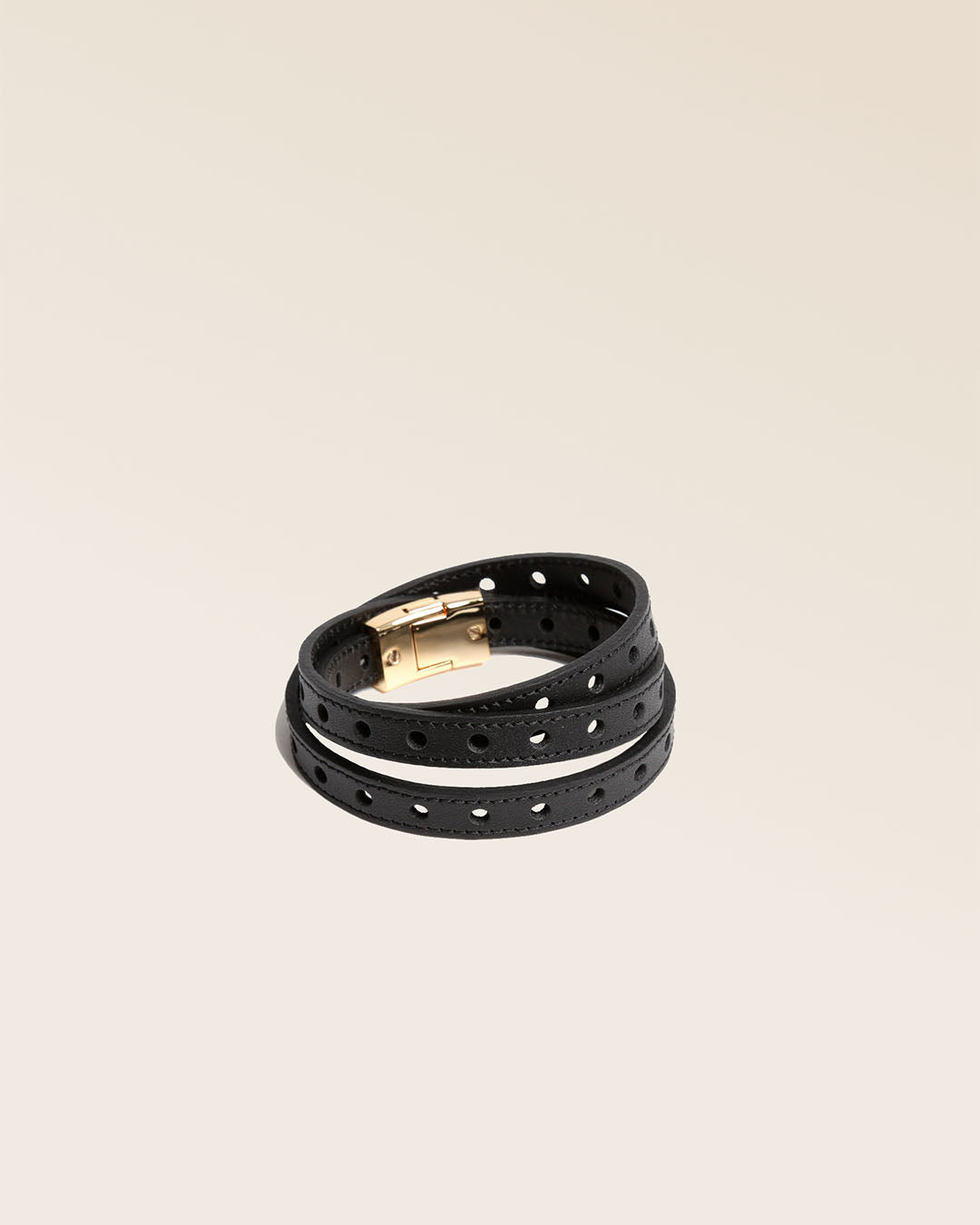 Our Totem Renouard bracelet in black perforated lambskin, seen from the quarter in the studio.