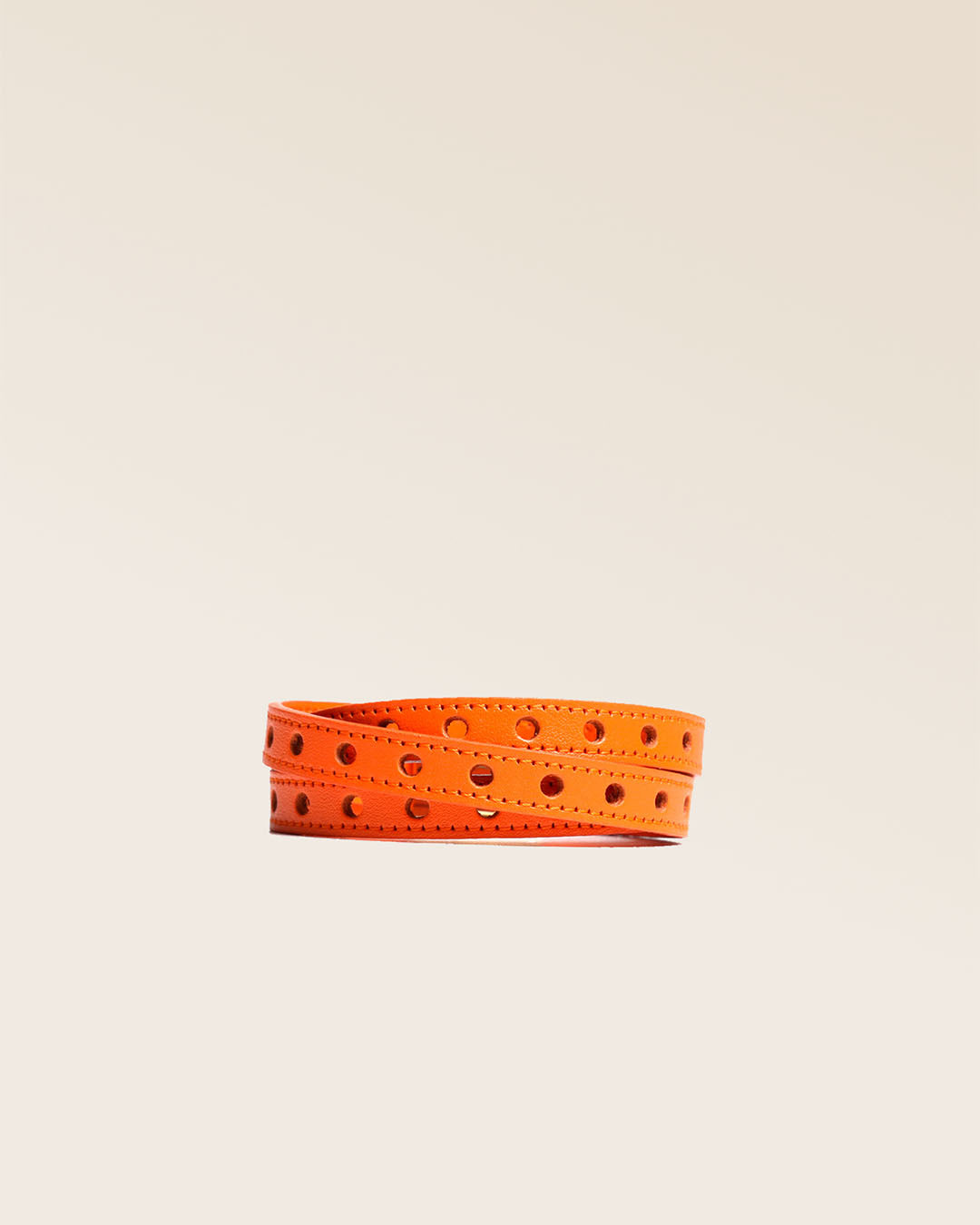 Our Totem bracelet in black perforated lambskin seen from the front in the studio.
