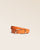 Our Marina belt in orange vicuña-style leather, seen from the front in the studio.