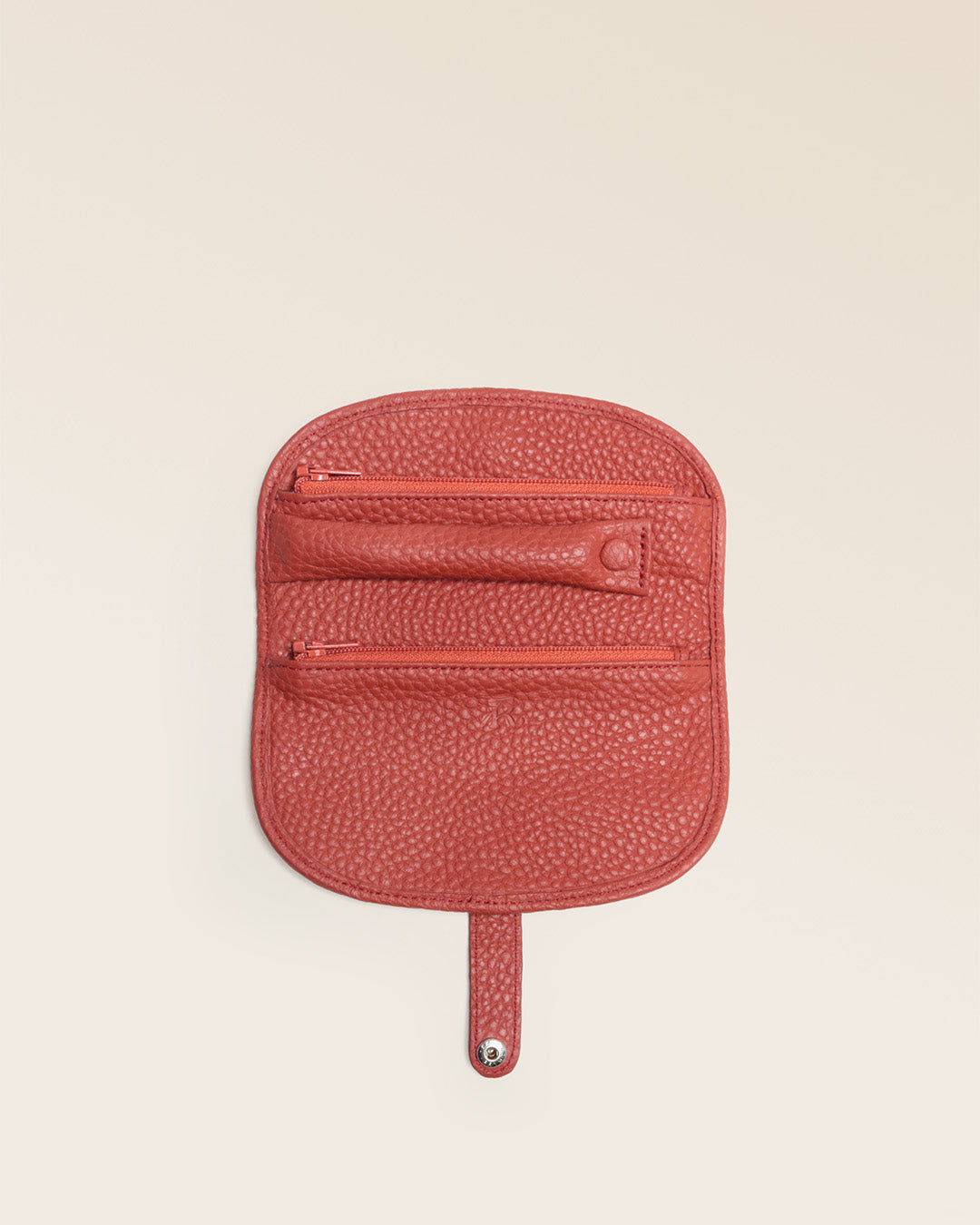 Our terracotta vicuña-style leather jewelry case, seen from the front in the studio.