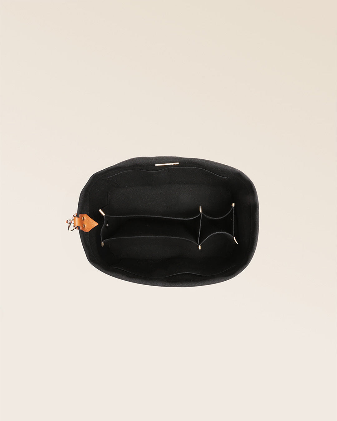 Our black suede bag organizer seen from above in the studio.
