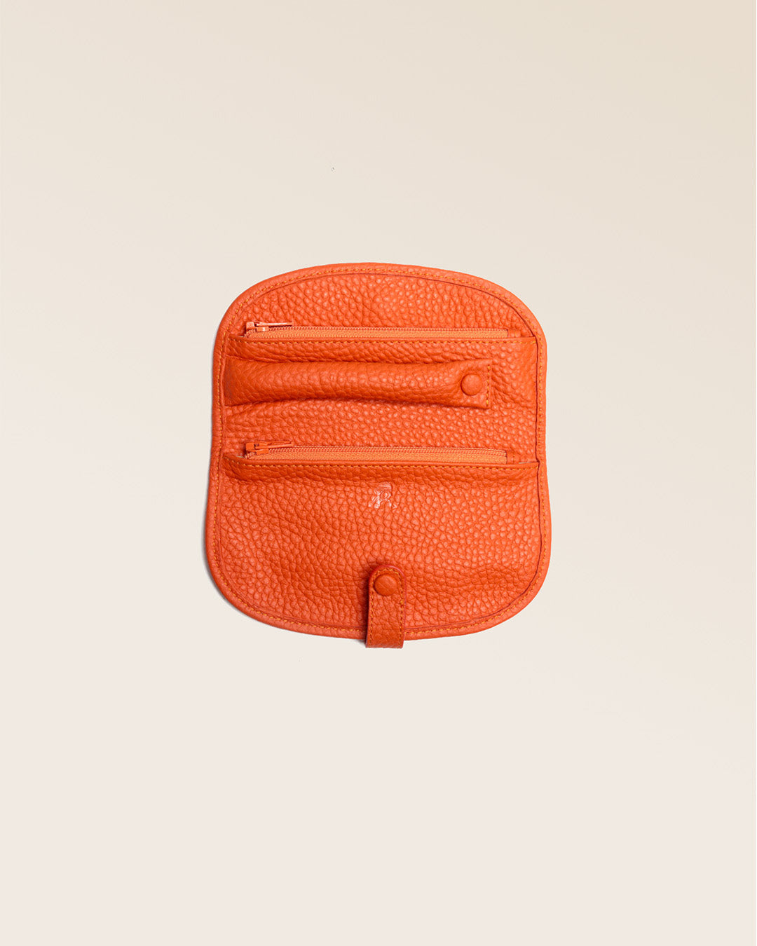 Our orange vicuña-style leather jewelry case seen open in the studio.