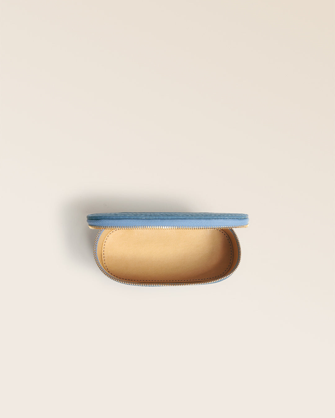Our Renouard lipstick case in cobalt-blue vicuña leather, seen from the top when open in the studio.