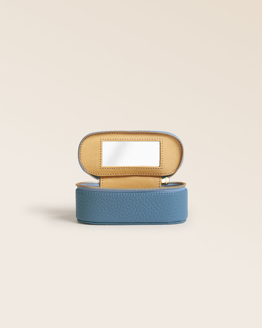Our Renouard lipstick case in cobalt-blue vicuña leather, seen from the front, open in the studio.