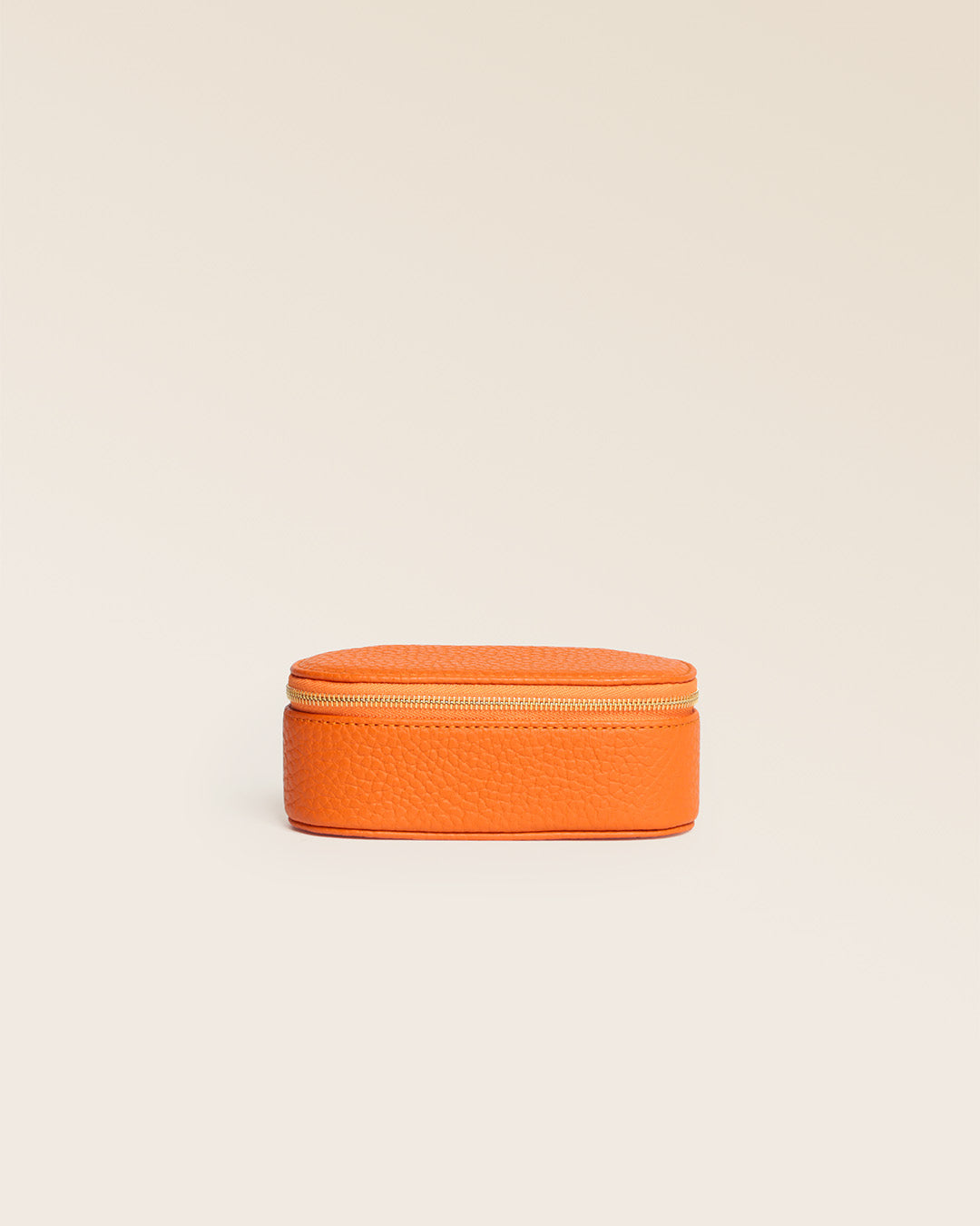 Our orange vicuña-style leather lipstick case seen from the front, closed in the studio.