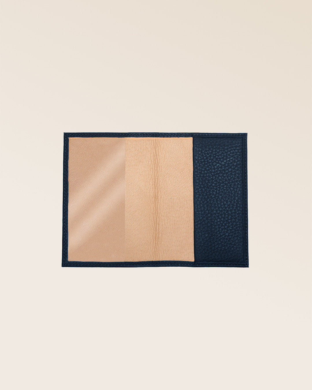 Our navy blue vicuña-style leather passport holder, seen from the front in the studio.