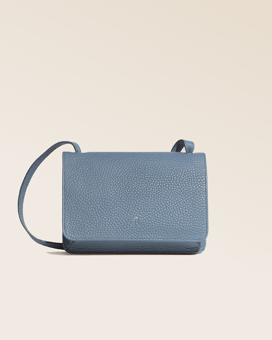Our Frehel clutch bag in cobalt-blue vicuña-style leather, seen from the front in the studio.