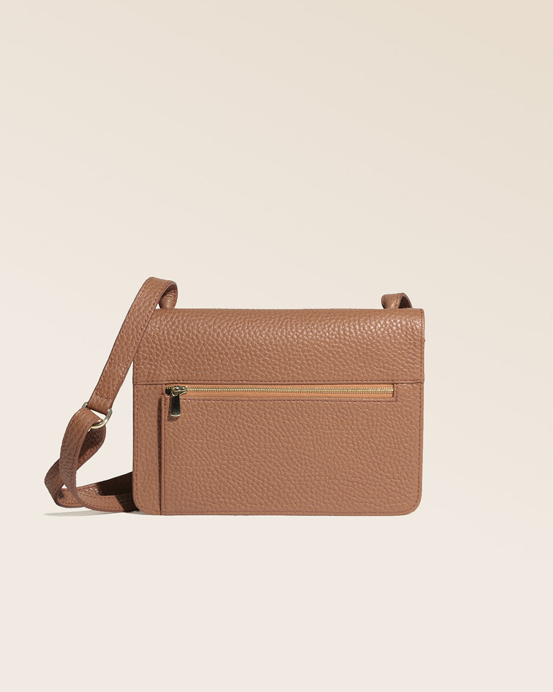 Our Fréhel clutch in fawn-colored vicuña leather, seen from the back in the studio.