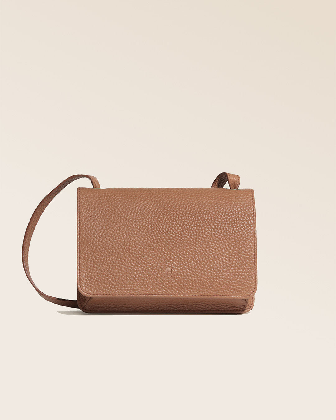 Our Fréhel clutch in fawn-colored vicuña leather, seen from the front in the studio.