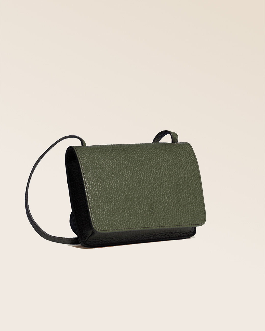 Our Frehel clutch in khaki vicuña-style leather, seen from the quarter in the studio.