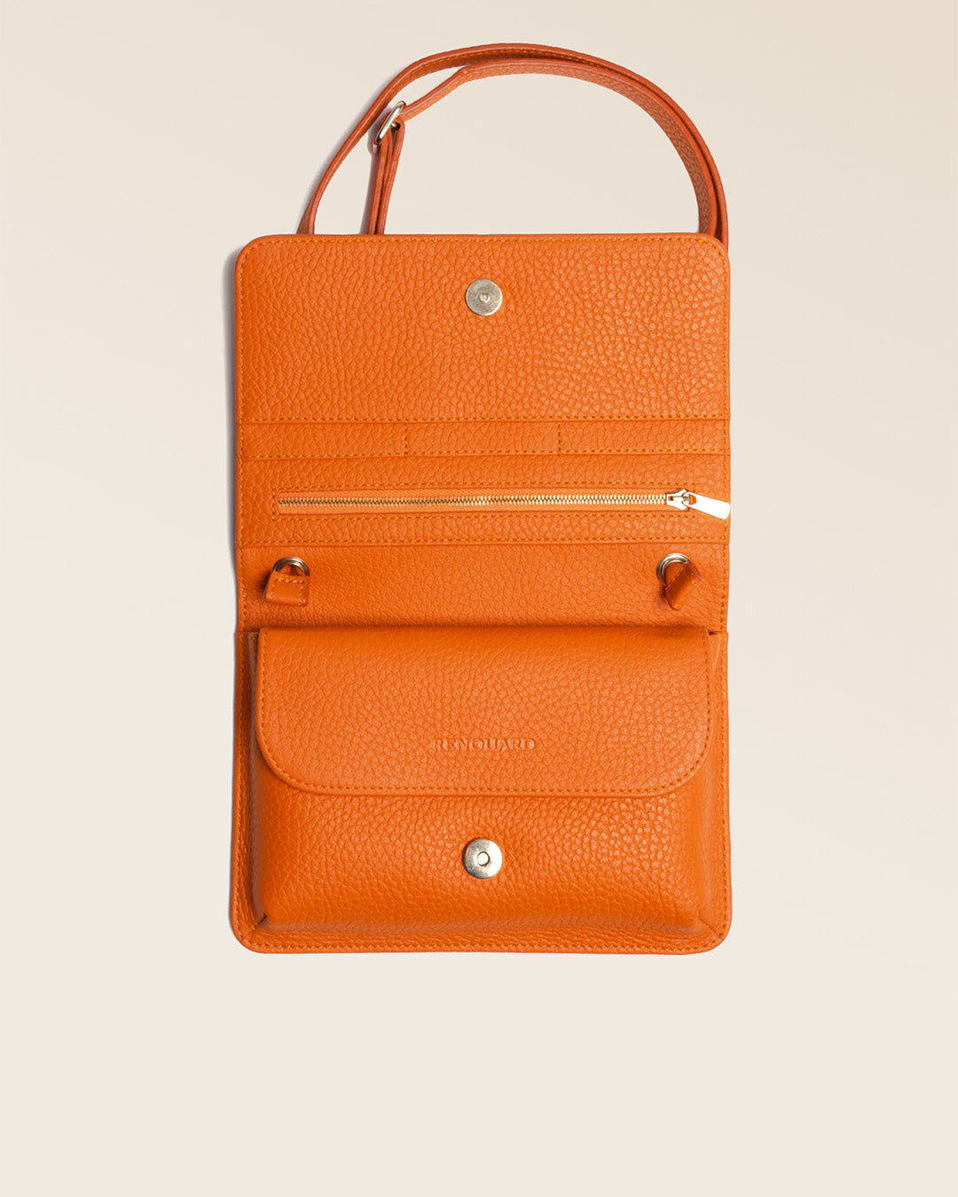 Our Fréhel clutch bag in orange vicuña-style leather, seen from above in the studio.