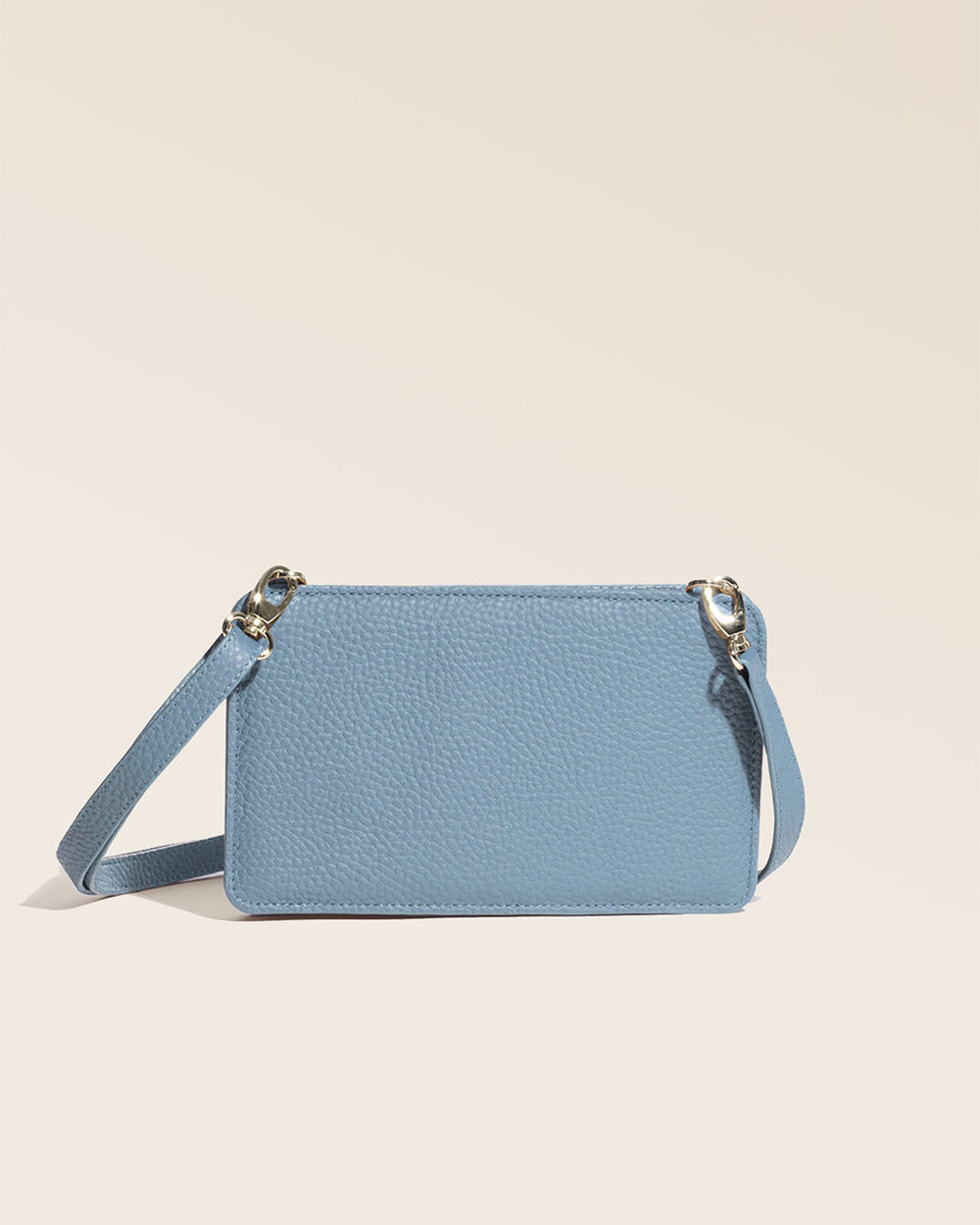 Our cobalt-blue vicuña-style leather Manolo clutch seen from the back in the studio.