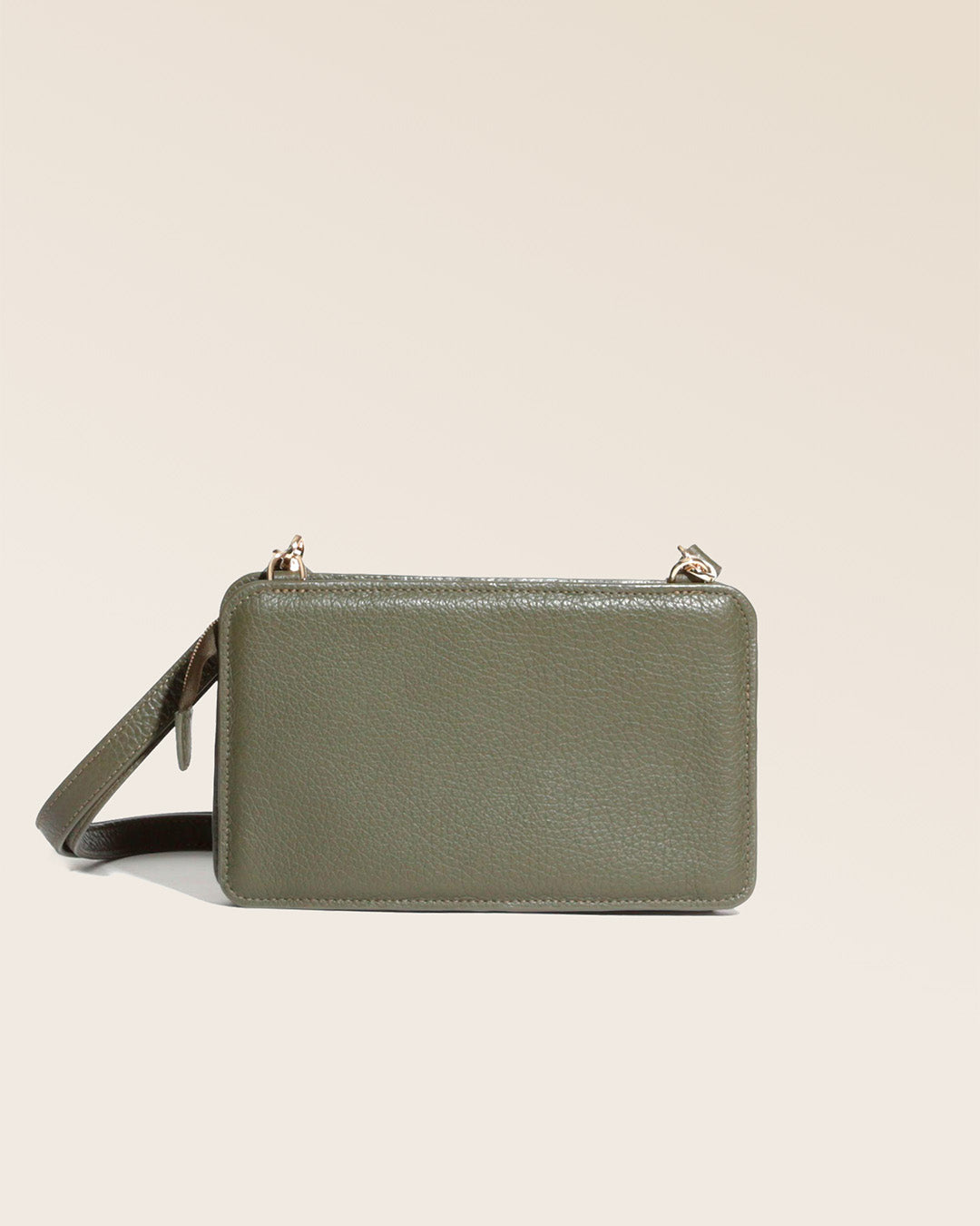 Our khaki vicuña-style leather Manolo clutch seen from the back in the studio.
