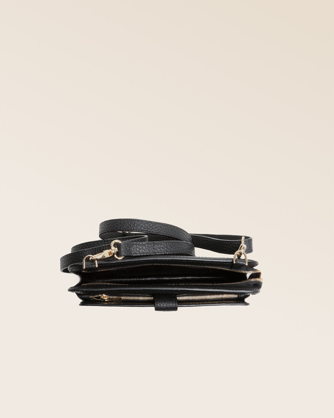 Our black vicuña-style leather Manolo clutch seen from above in the studio.