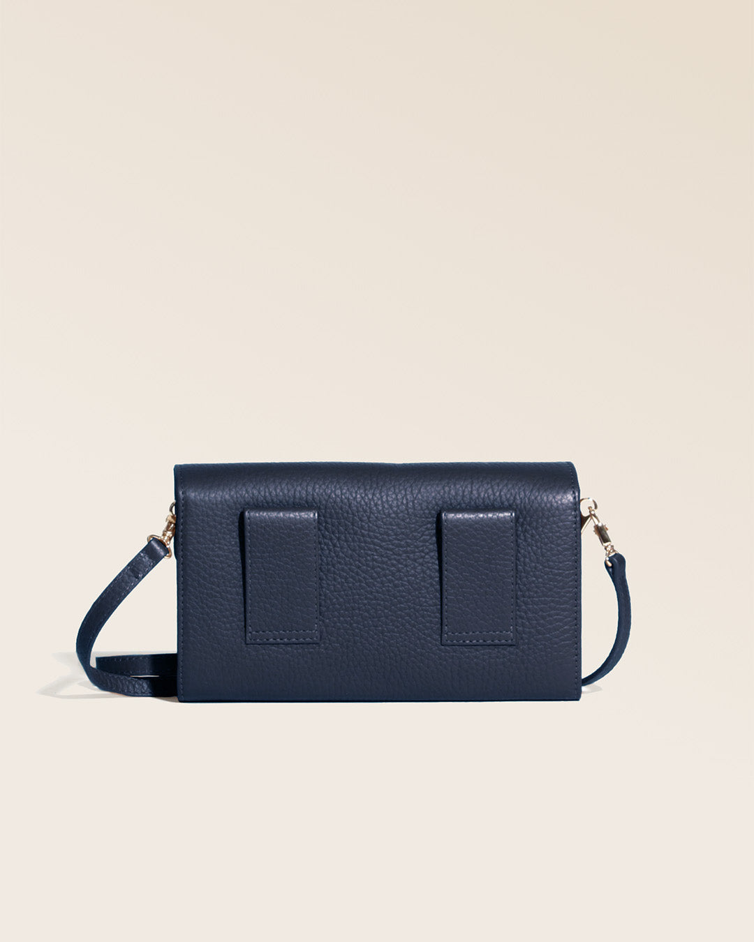 Our Raphaël clutch bag in navy blue vicuña-style leather, seen from the back in the studio.