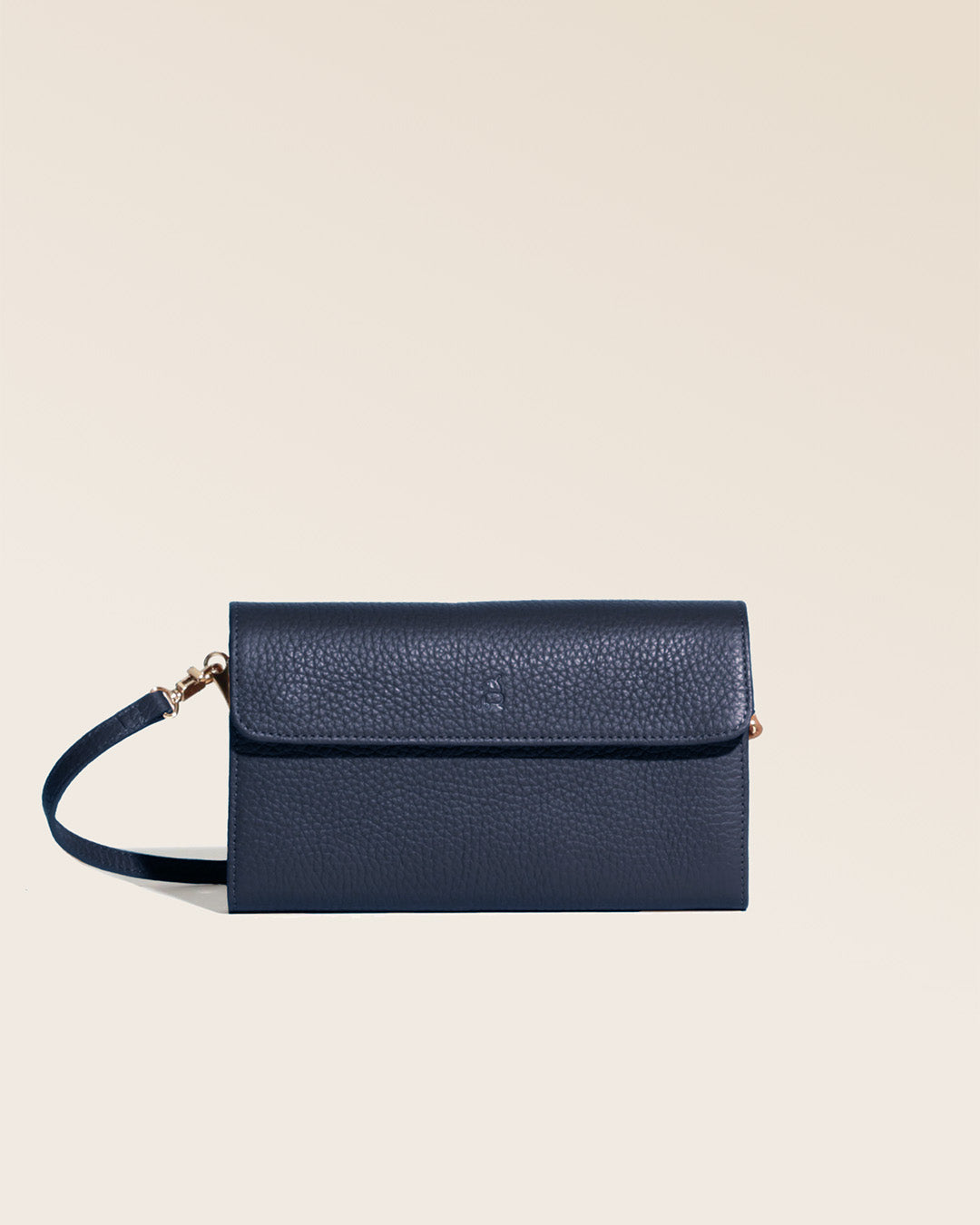 Our Raphaël clutch bag in navy blue vicuña-style leather, seen from the front in the studio.