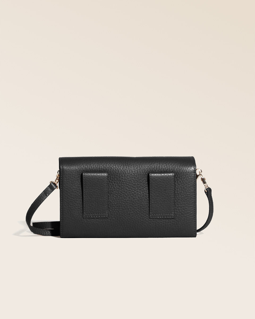 Our Raphaël clutch in black vicuña-style leather, seen from the back in the studio.