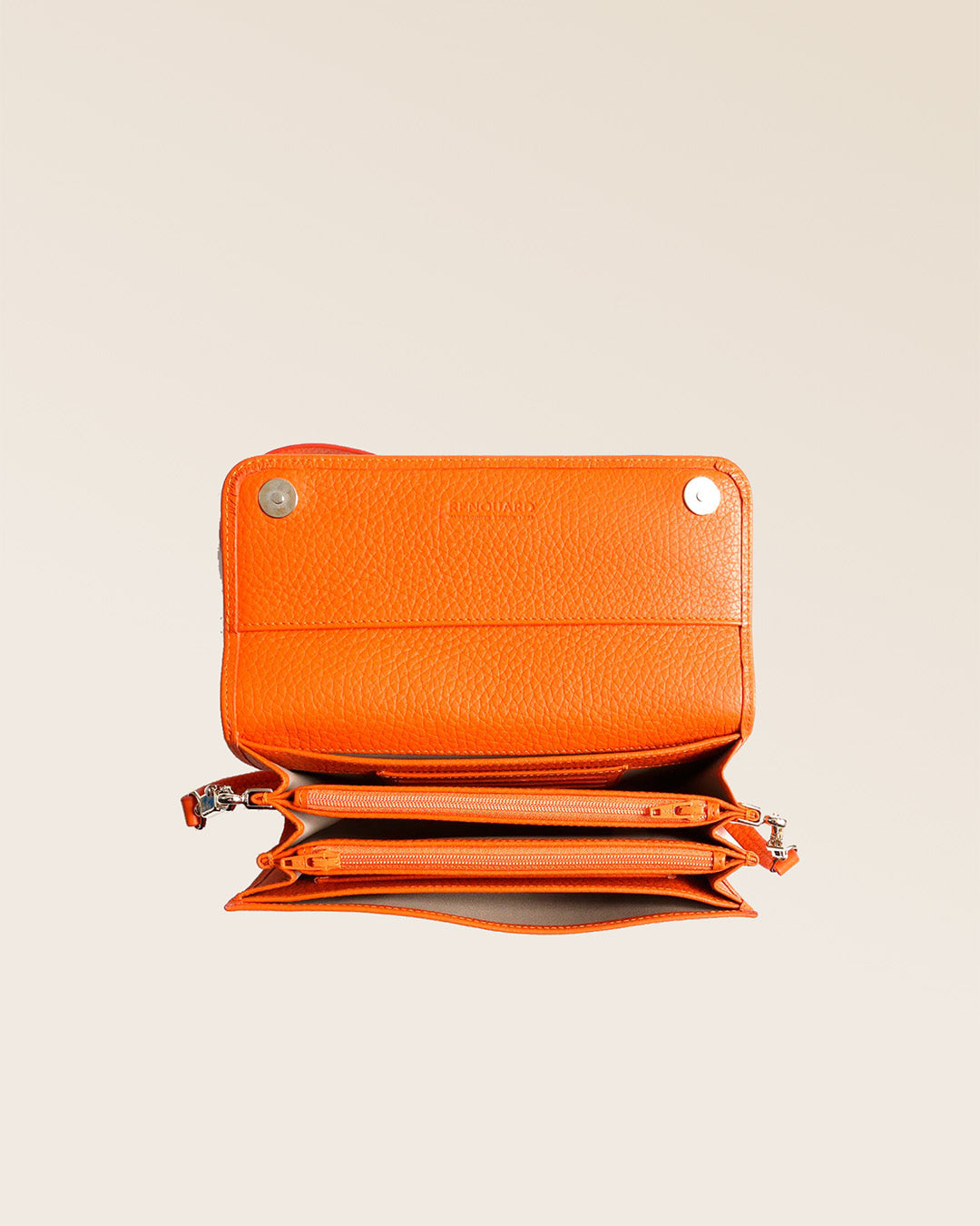 Notre pochette Raphaël en cuir façon vigogne orange vue du dessus en studio.