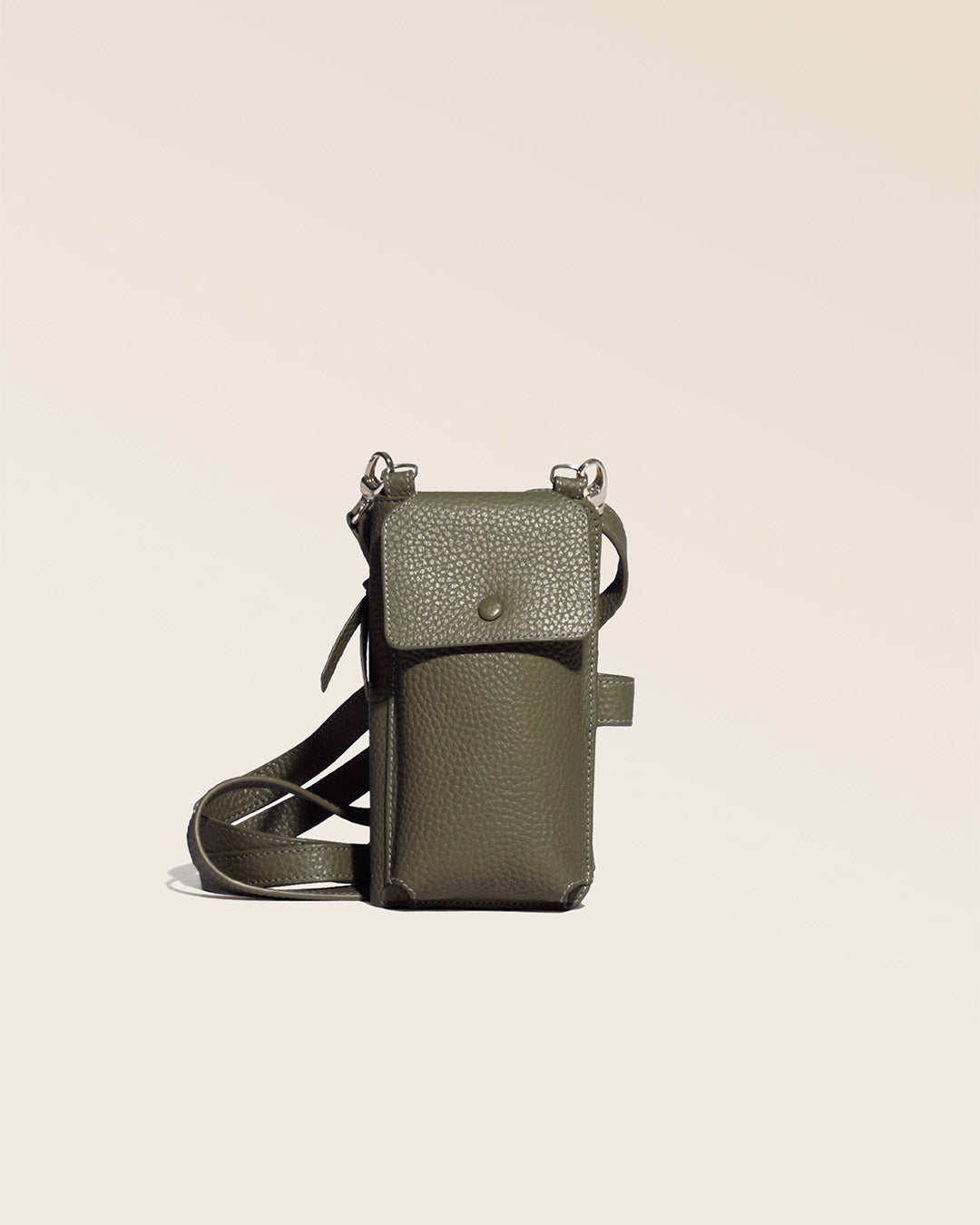 Our Tempo clutch bag in khaki vicuña-style leather, seen from the front in the studio.