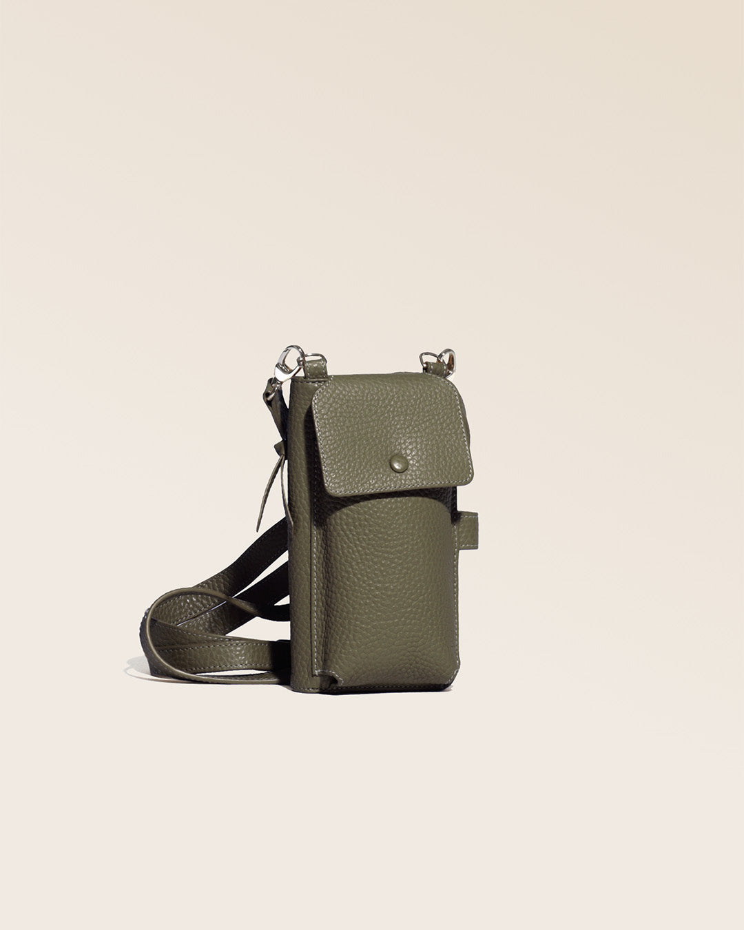 Our Tempo clutch bag in khaki vicuña-style leather, seen from the quarter in the studio.