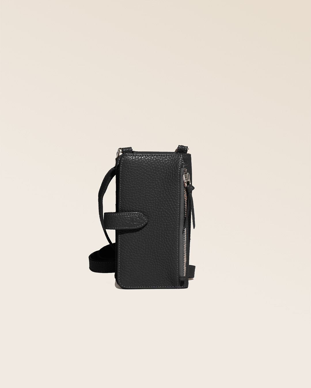 Our black vicuña-style leather Tempo clutch seen from the back in the studio.