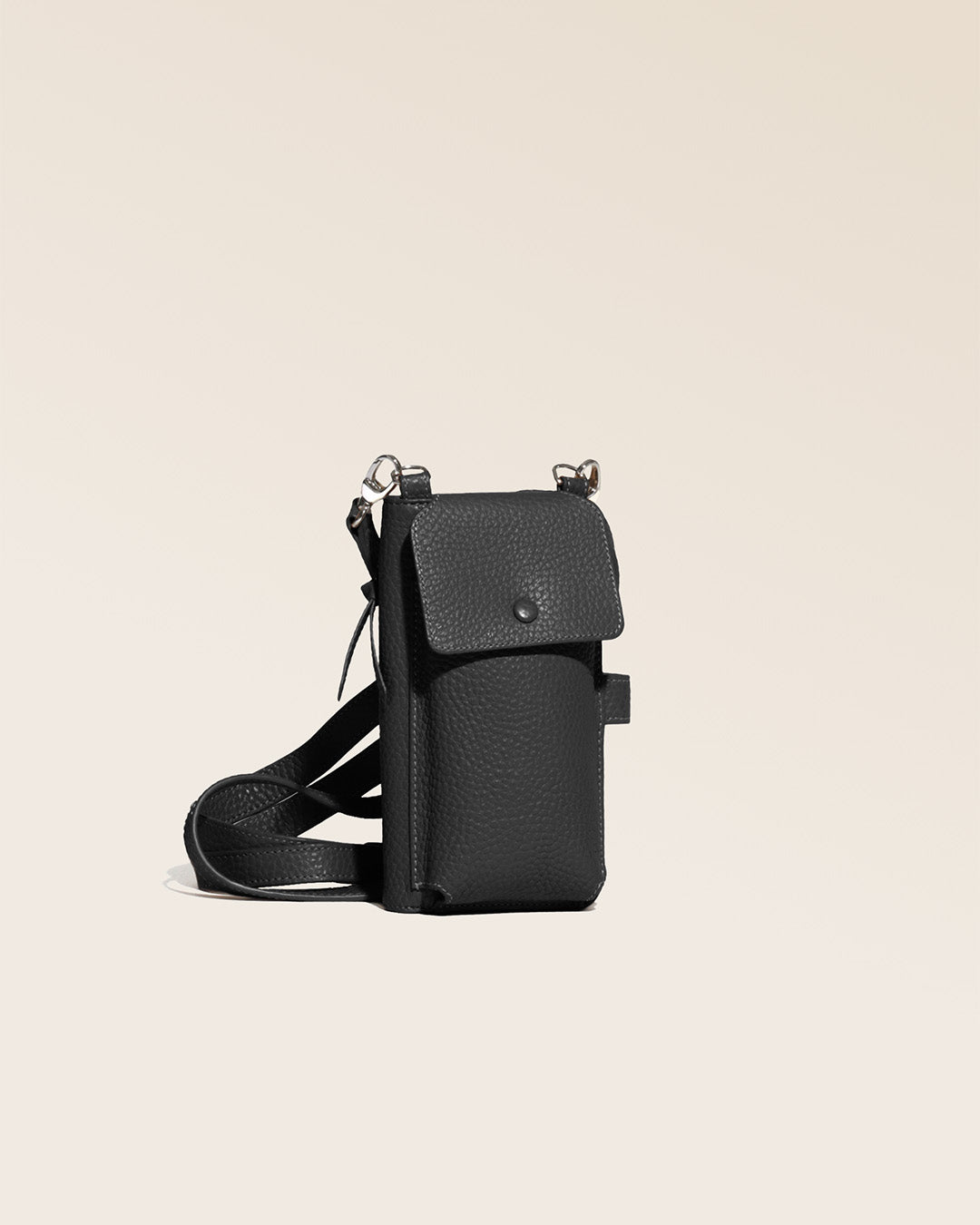 Our Tempo clutch in black vicuña-style leather, seen from the quarter in the studio.
