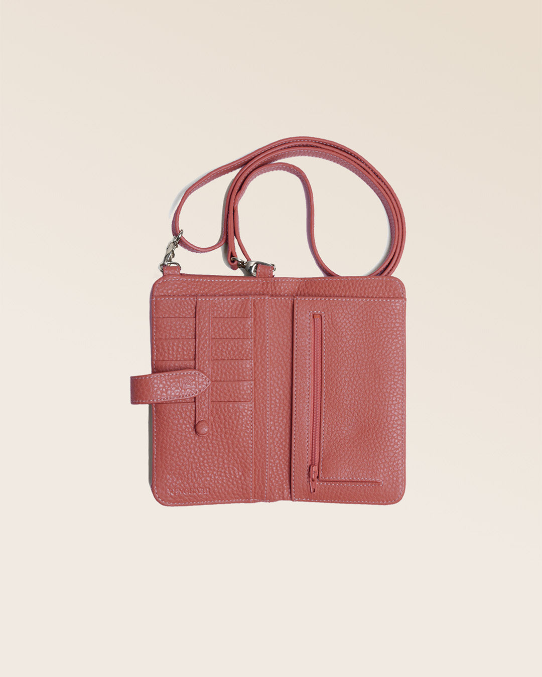 Our Tempo clutch bag in terracotta vicuña-style leather, seen from above in the studio.