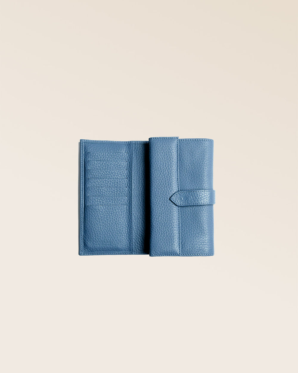 Our Adèle wallet in cobalt-blue vicuña-style leather, seen open in the studio.