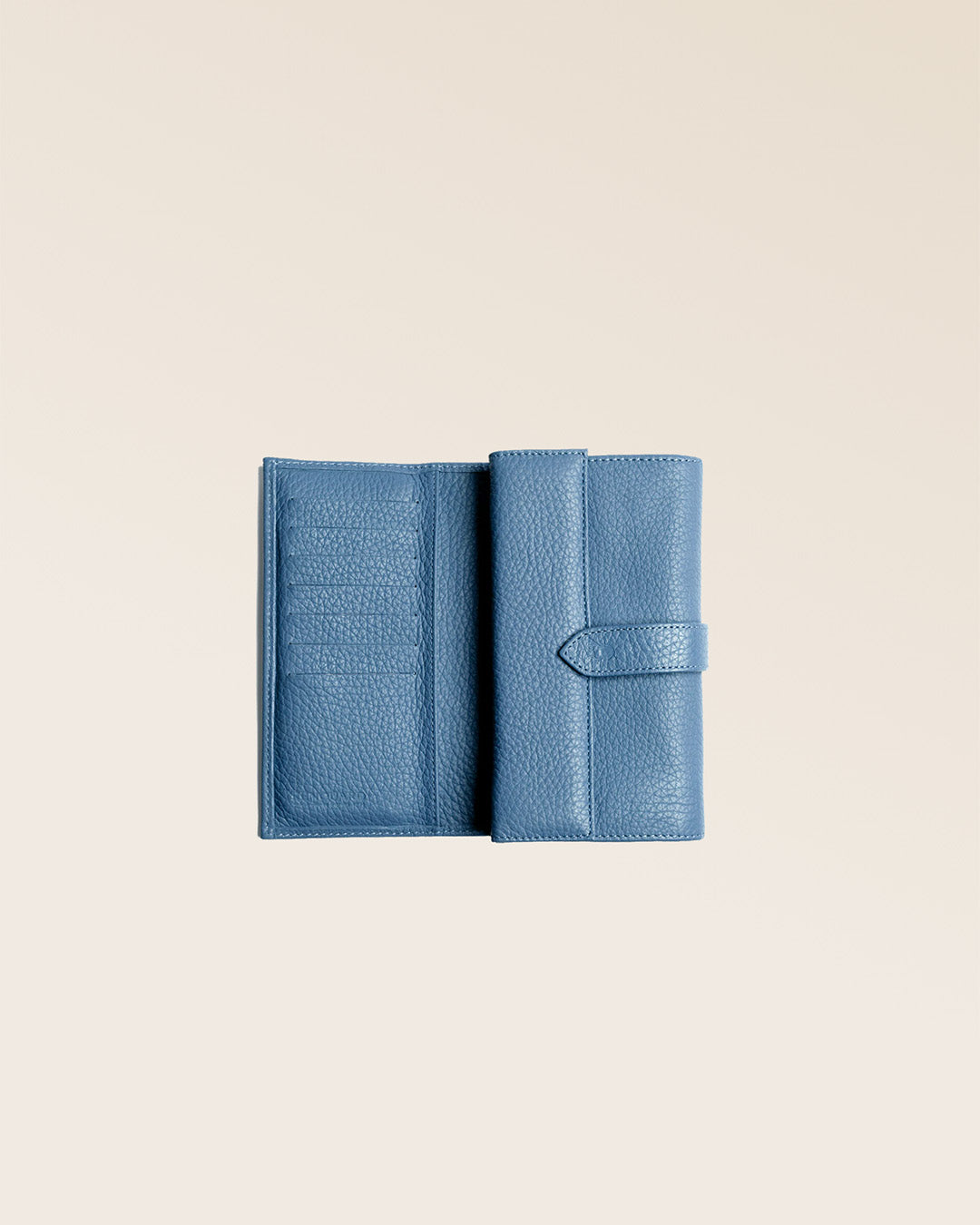 Our Adèle wallet in cobalt-blue vicuña-style leather, seen open in the studio.