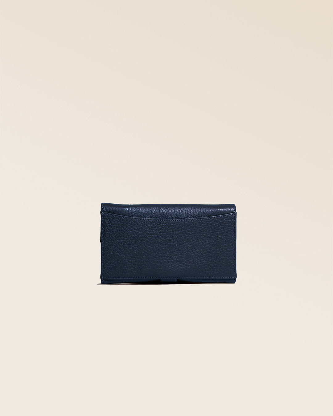 Our Adèle wallet in navy blue vicuña-style leather, seen from the back in the studio.