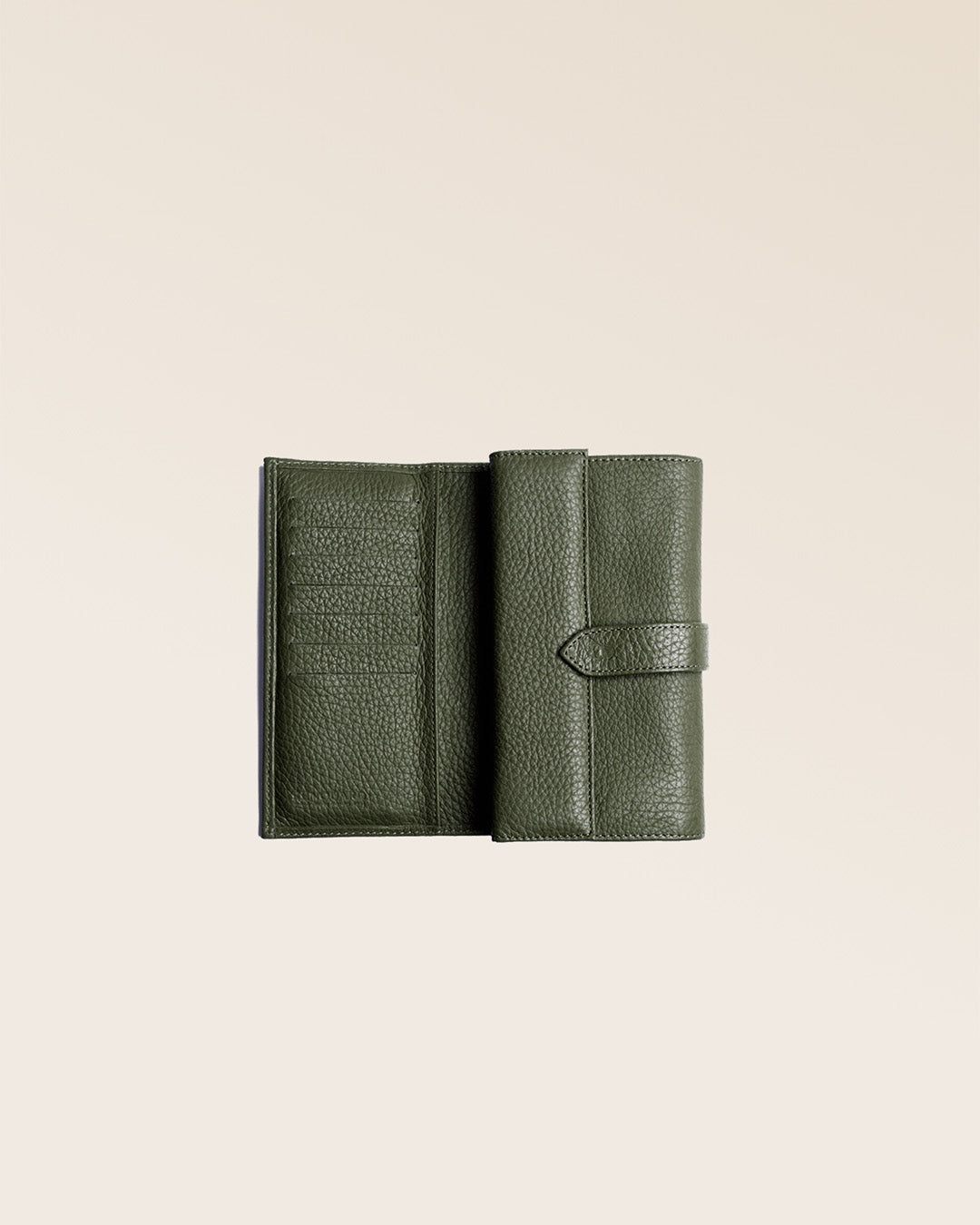 Our Adèle Renouard wallet, in khaki vicuña-style leather, seen open in the studio.