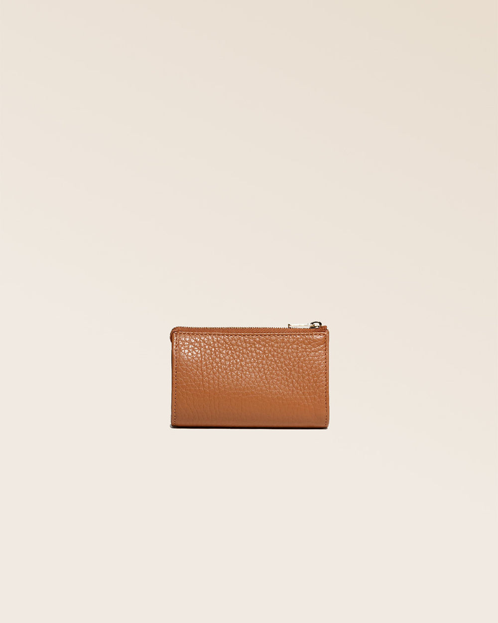 Notre porte-monnaie Birdy en cuir façon vigogne fauve vu de dos en studio.
