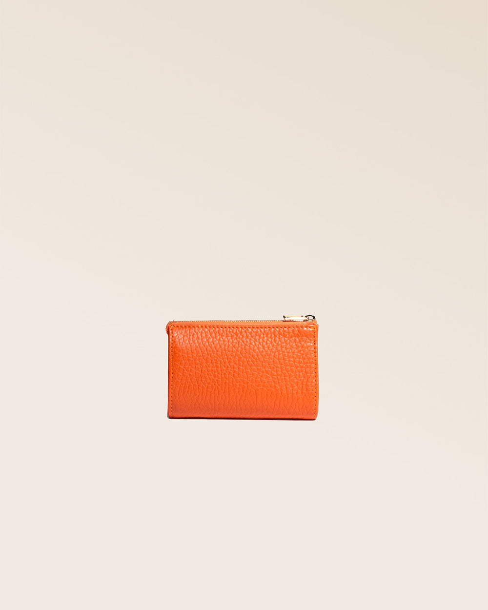 Our Birdy purse in orange vicuña-style leather, seen from the back in the studio.