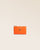 Our Birdy wallet in orange vicuña-style leather, seen from the front in the studio.