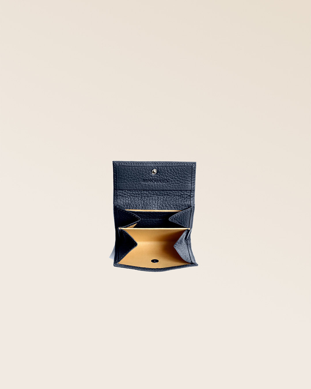 Our Mixte wallet in navy blue vicuña-style leather seen open in the studio.