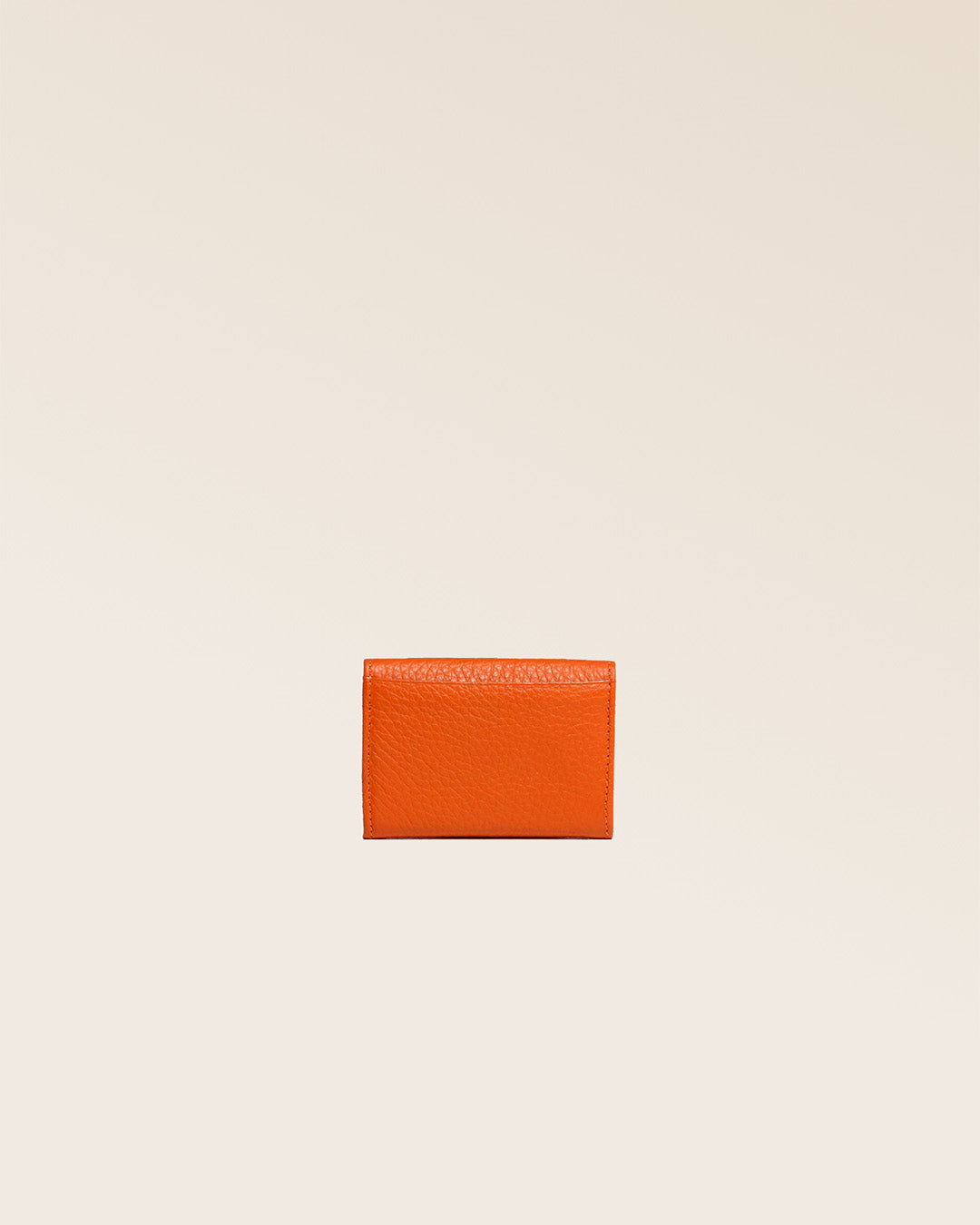 Our Mixte orange vicuña-style leather wallet seen from the back in the studio.