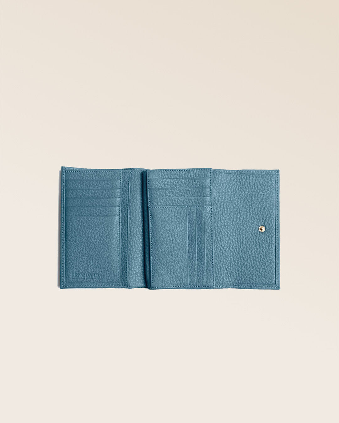Notre porte-monnaie Opale en cuir façon vigogne bleu cobalt vu ouvert en studio.
