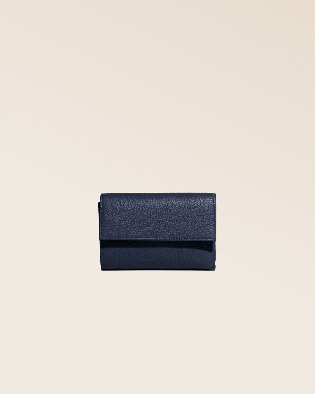 Our Opale wallet in navy blue vicuña leather as seen from the front in the studio.