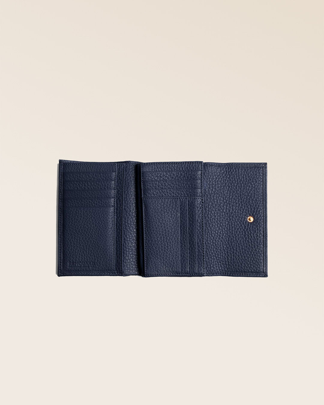 Our Opale wallet in navy blue vicuña leather seen open in the studio.