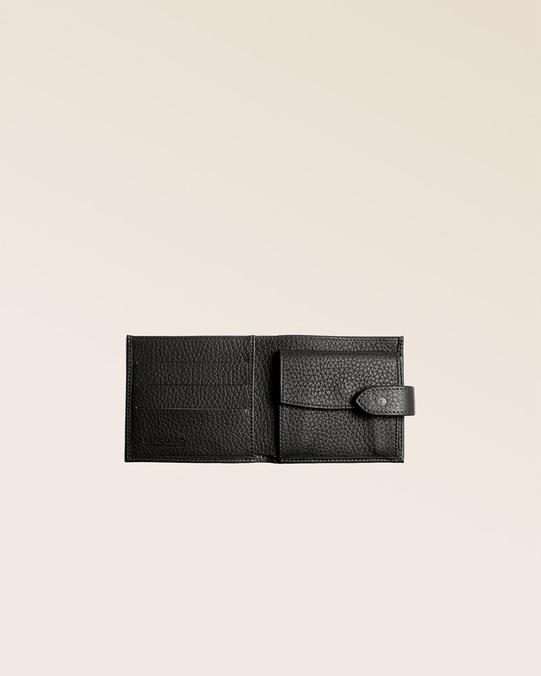 Our Rabat wallet in black vicuña-style leather seen open in the studio.