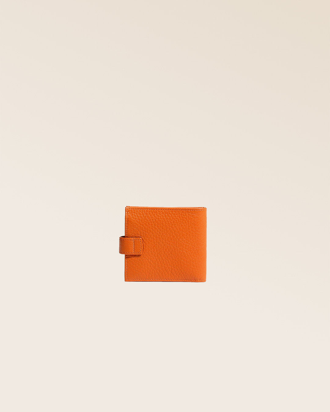 Our orange vicuña-style leather Rabat purse seen from the back in the studio.