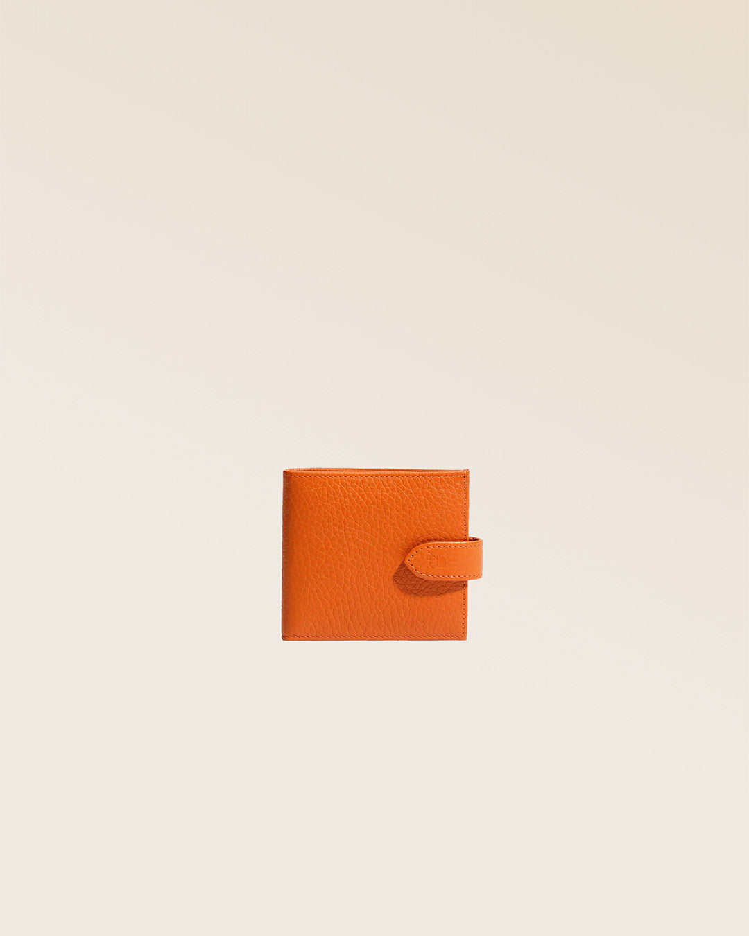 Our orange vicuña-style leather Rabat wallet seen from the front in the studio.