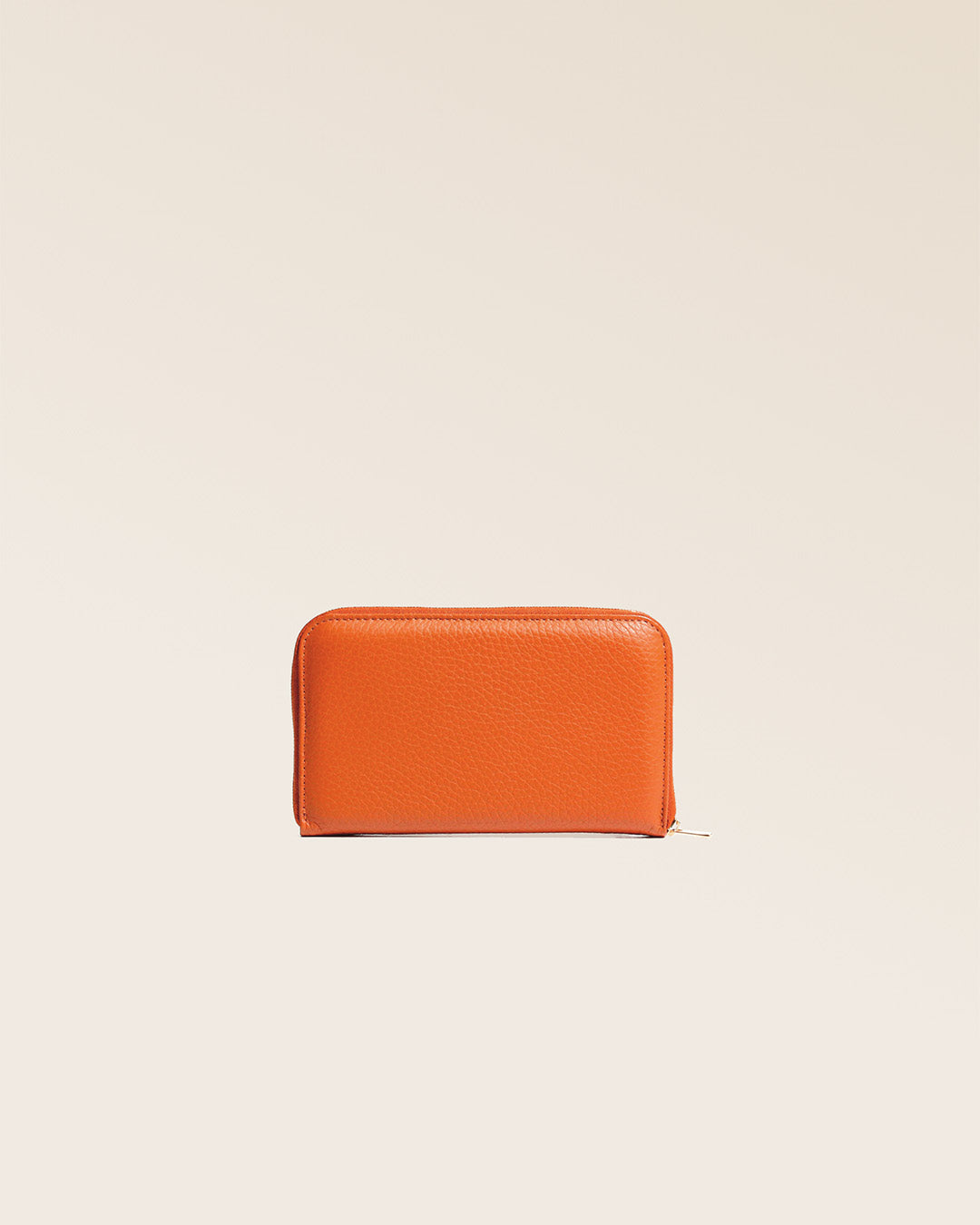 Our orange vicuña-style leather Samba purse seen from the back in the studio.