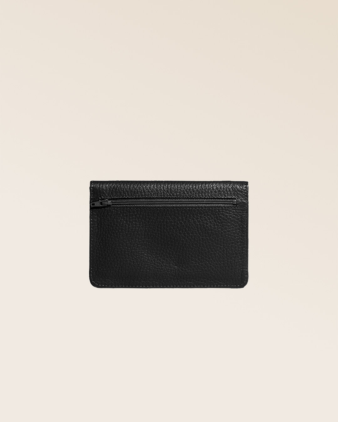 Our Aurore paperweight in black vicuña-style leather, seen from the back in the studio.